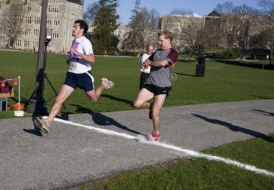 The first runners cross the finish line at the 3.2 Mile Run in Remembrance.