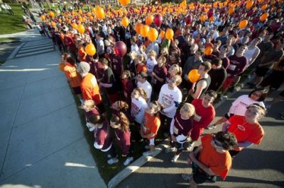Participants in the 3.2 Mile Run in Remembrance watch the release of 32 white balloons before the start.